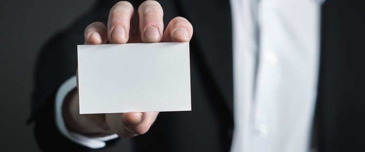 Man holding blank card, not identifying with his addiction.