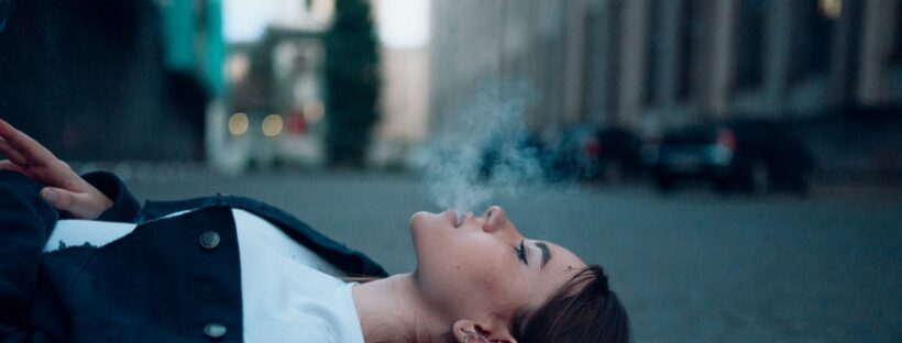 Woman laying down smoking in Massachusetts
